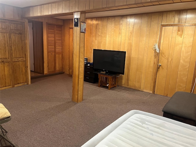 living room featuring light carpet and wood walls