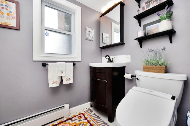 bathroom with vanity, toilet, and a baseboard heating unit