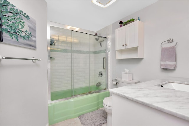 full bathroom with vanity, shower / bath combination with glass door, and toilet