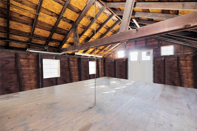 interior space featuring wood ceiling and wooden walls