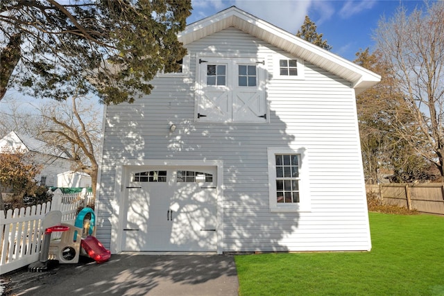 exterior space with an outbuilding, a garage, and a front yard