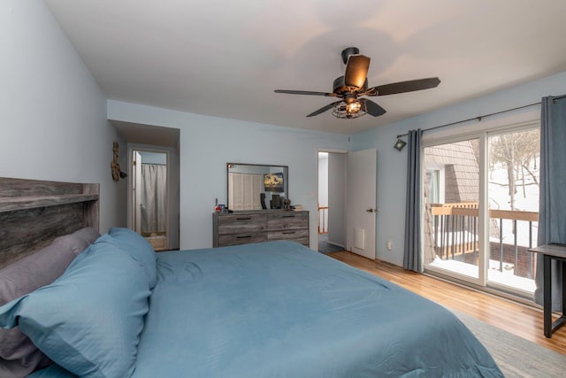 bedroom with ceiling fan, wood finished floors, and access to outside