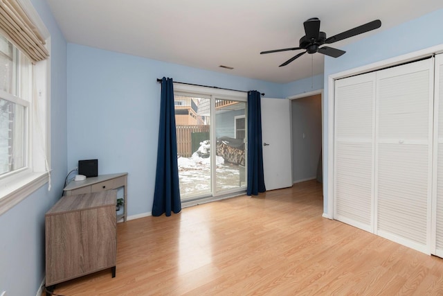 bedroom with a ceiling fan, visible vents, baseboards, a closet, and light wood-type flooring