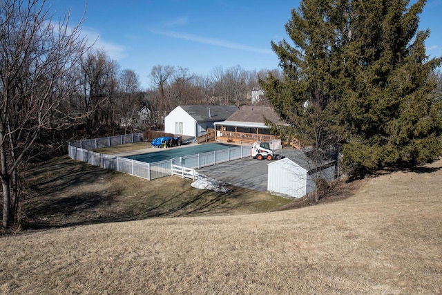 view of pool featuring a lawn and fence