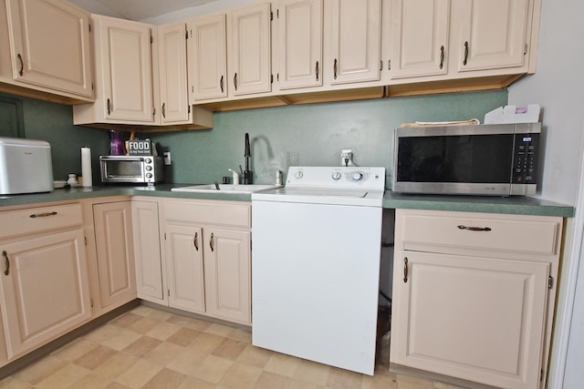 laundry area featuring sink and washer / dryer