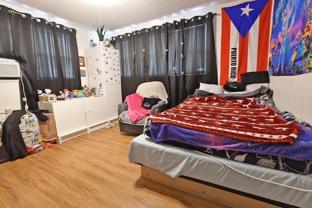 bedroom featuring hardwood / wood-style flooring and ornamental molding