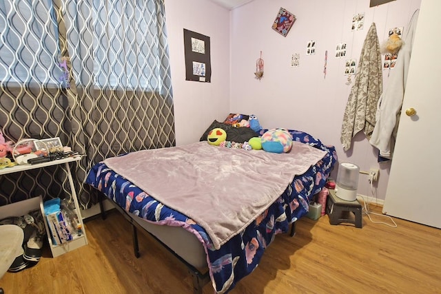 bedroom featuring wood-type flooring