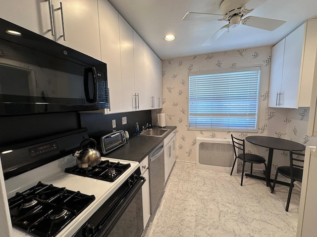 kitchen with sink, black appliances, white cabinets, and ceiling fan