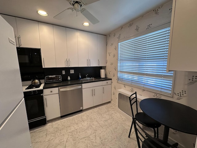 kitchen featuring ceiling fan, sink, white cabinetry, and black appliances