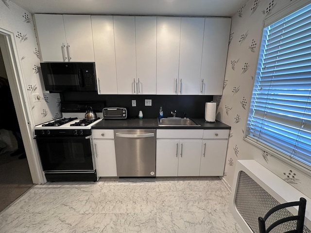 kitchen with sink, heating unit, white cabinets, and black appliances