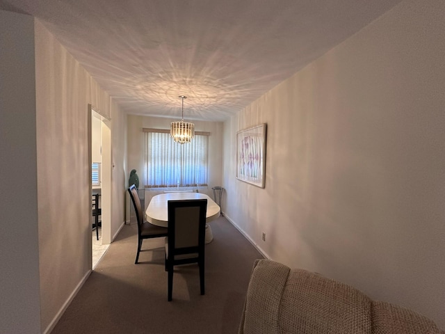 dining space with light colored carpet and a notable chandelier