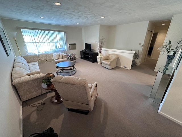 carpeted living room with a wall mounted AC and a textured ceiling