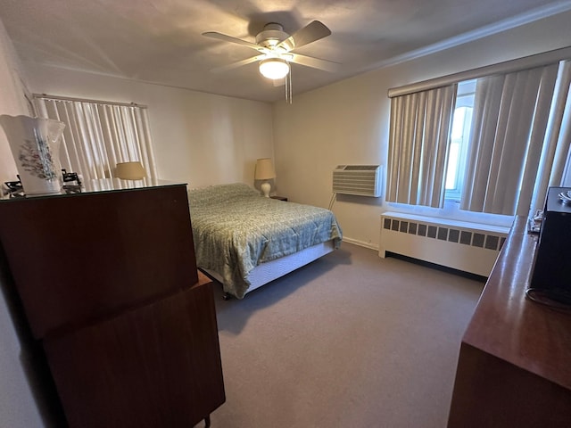 carpeted bedroom featuring a wall mounted AC, radiator, and ceiling fan