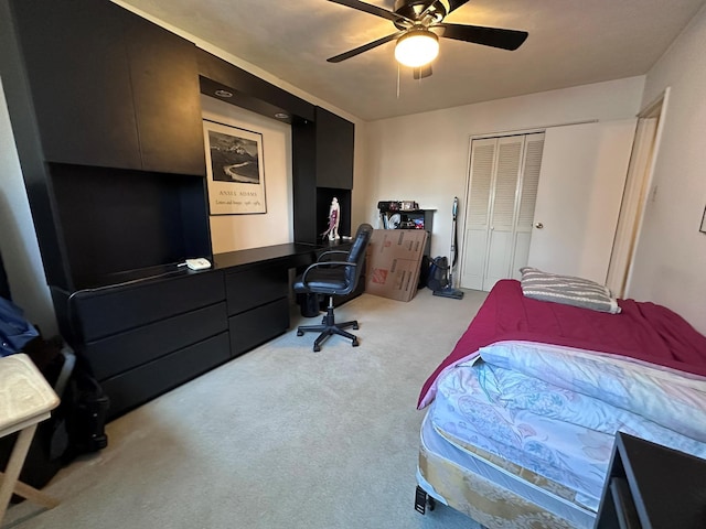 carpeted bedroom featuring a closet and ceiling fan