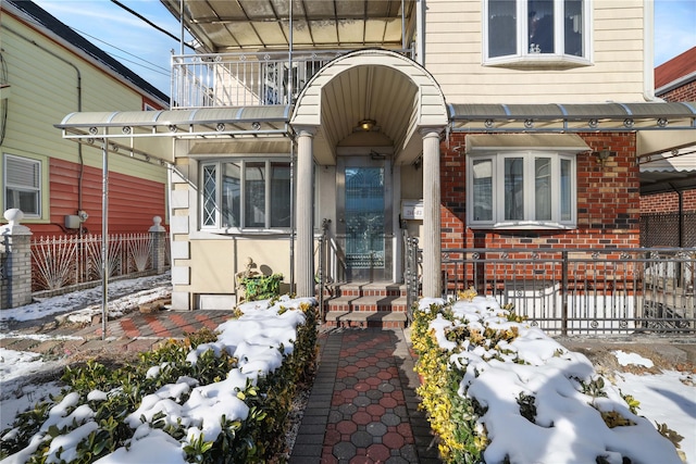 view of snow covered property entrance