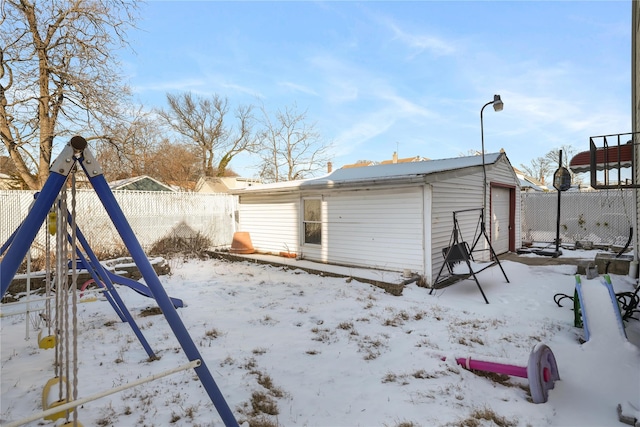 exterior space with an outbuilding, a garage, and a playground