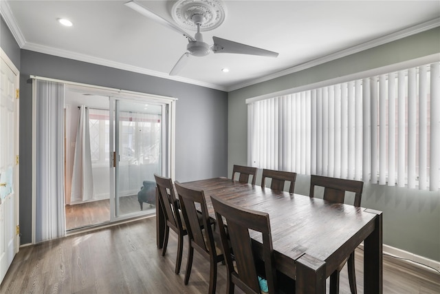 dining space with hardwood / wood-style floors, crown molding, and ceiling fan