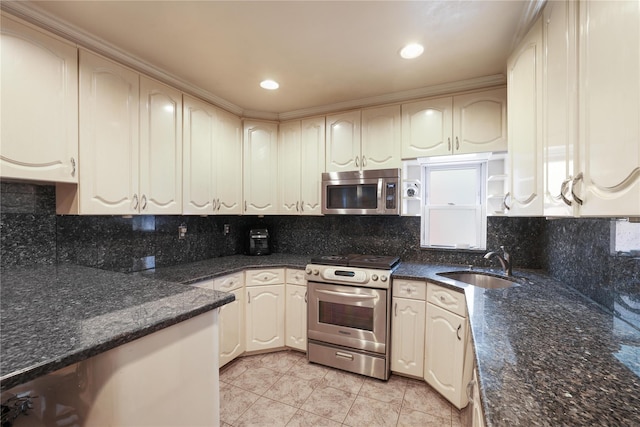 kitchen featuring stainless steel appliances, tasteful backsplash, sink, and light tile patterned floors