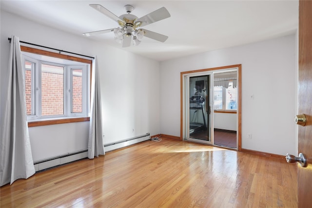 unfurnished room with ceiling fan, light hardwood / wood-style floors, and a baseboard heating unit