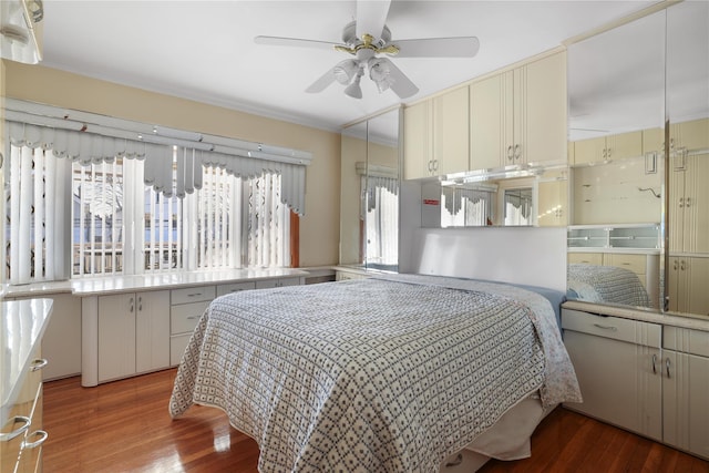 bedroom with dark hardwood / wood-style floors and ceiling fan