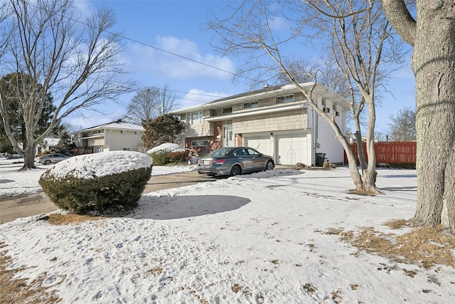 view of snowy exterior with a garage