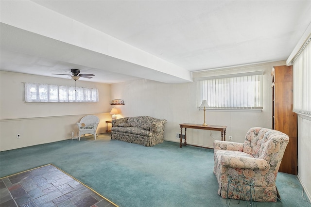 living area featuring ceiling fan and carpet floors