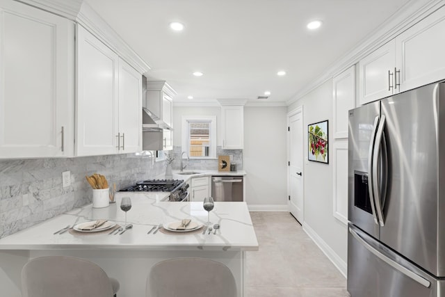 kitchen featuring white cabinetry, appliances with stainless steel finishes, and kitchen peninsula