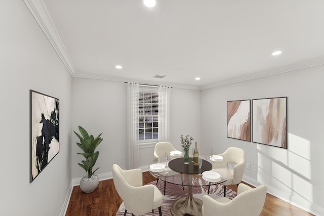 dining space featuring crown molding and hardwood / wood-style floors