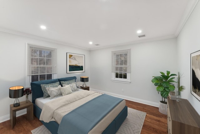 bedroom with crown molding and dark hardwood / wood-style floors