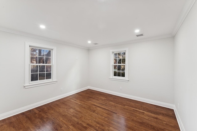 empty room with crown molding and dark wood-type flooring