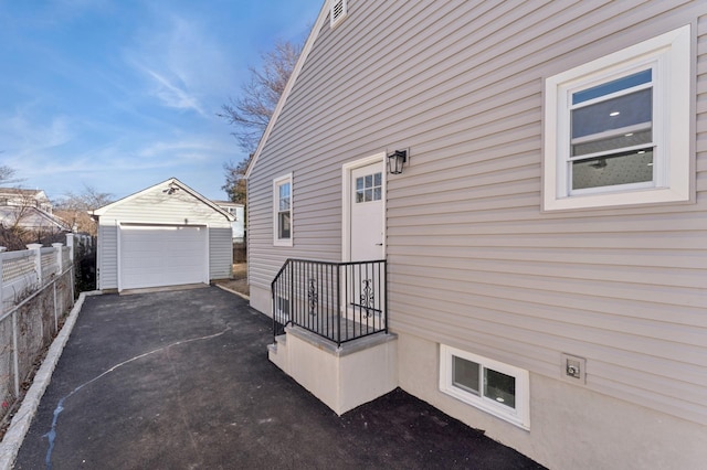 view of side of property with a garage and an outdoor structure