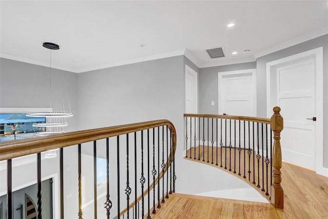 hall featuring crown molding and light hardwood / wood-style floors