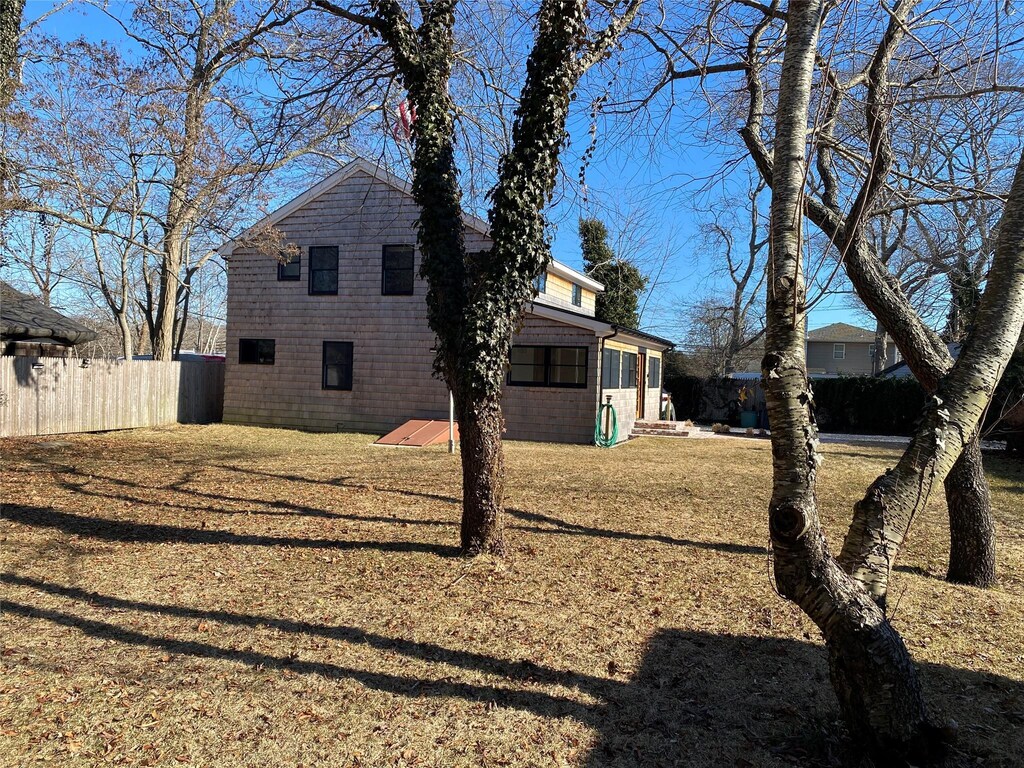 61 W Side Ave, East Quogue, NY 11942 - view of side of home with fence