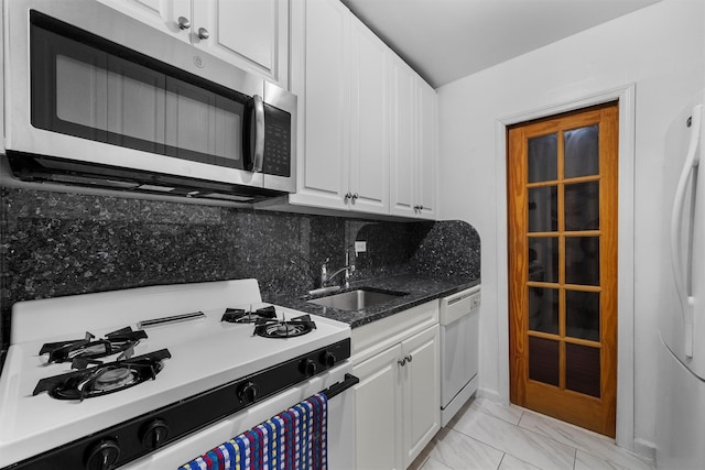 kitchen featuring tasteful backsplash, white appliances, sink, and white cabinets