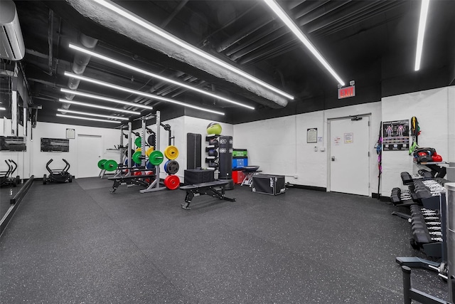 workout area featuring a wall mounted AC