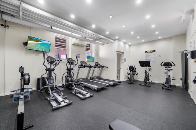 workout area featuring a wall mounted air conditioner