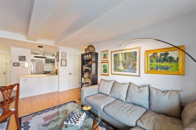 living room with hardwood / wood-style floors and beam ceiling