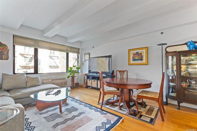 living room with beamed ceiling and hardwood / wood-style floors