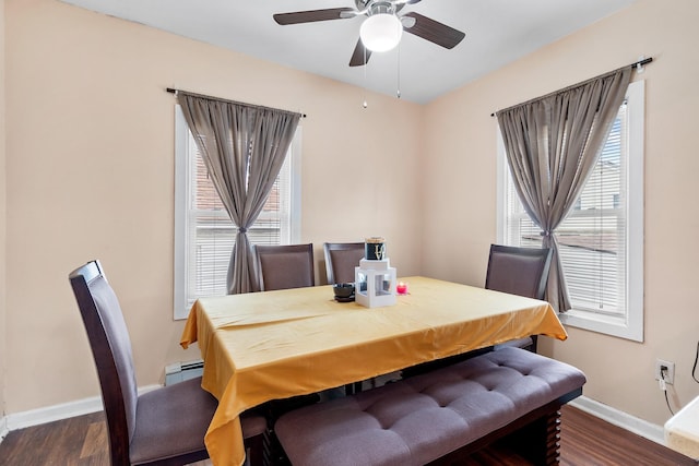 dining area featuring dark hardwood / wood-style flooring, a baseboard radiator, and ceiling fan