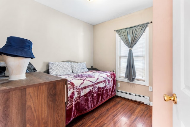 bedroom featuring a baseboard heating unit and dark wood-type flooring