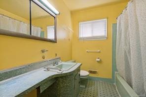 full bathroom featuring vanity, shower / tub combo with curtain, and toilet