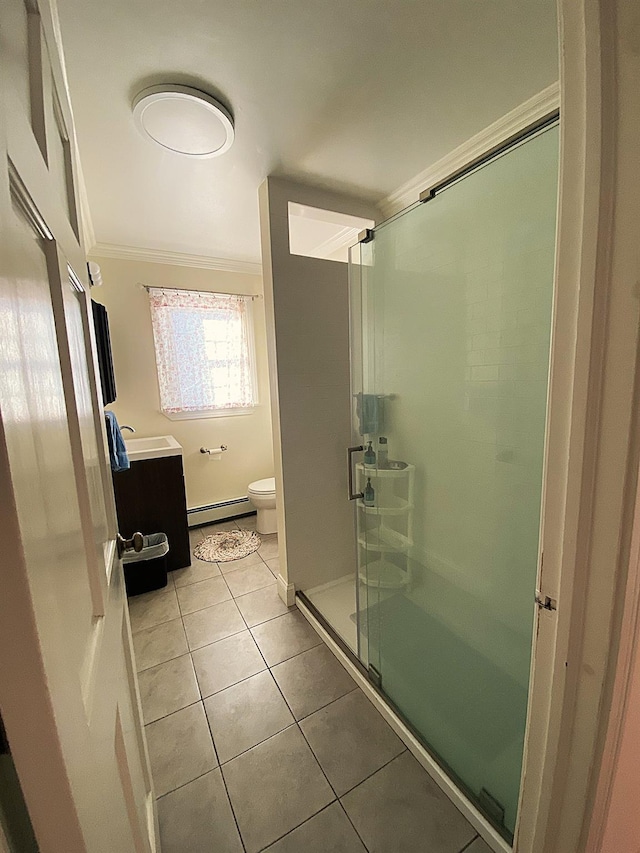 bathroom featuring tile patterned floors, a baseboard heating unit, vanity, walk in shower, and crown molding