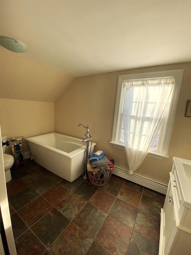 bathroom featuring a baseboard radiator, lofted ceiling, vanity, a bathtub, and toilet