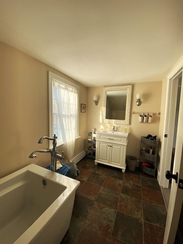 bathroom featuring a baseboard radiator, a bath, and vanity