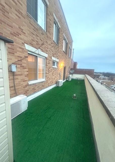 view of yard featuring a balcony and central AC