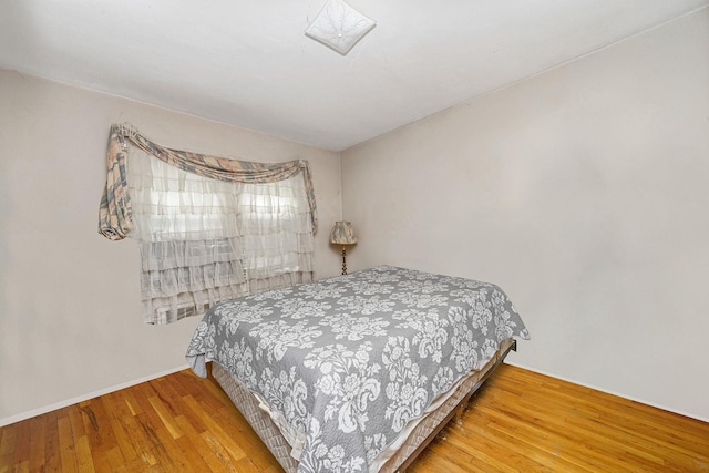 bedroom with hardwood / wood-style floors