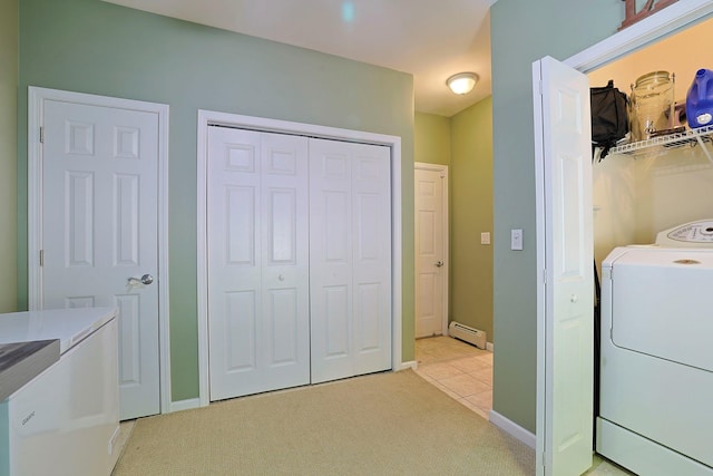 laundry area featuring washer / dryer, a baseboard heating unit, and light carpet