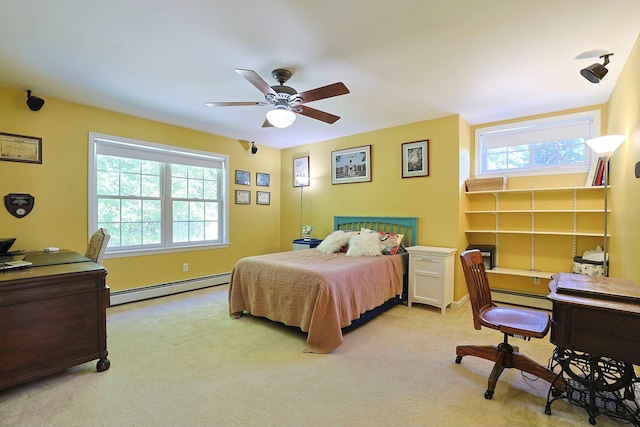 bedroom featuring light carpet, a baseboard heating unit, and ceiling fan