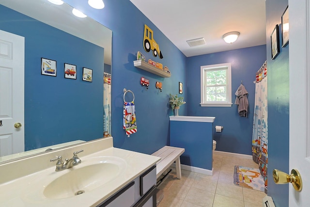 bathroom featuring vanity, a baseboard radiator, tile patterned floors, and toilet