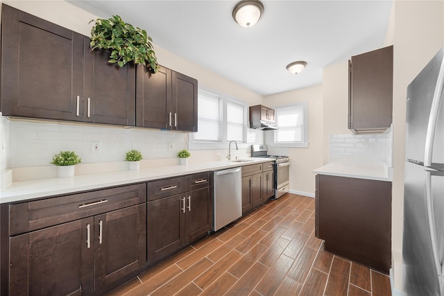 kitchen with sink, tasteful backsplash, dark brown cabinetry, and appliances with stainless steel finishes